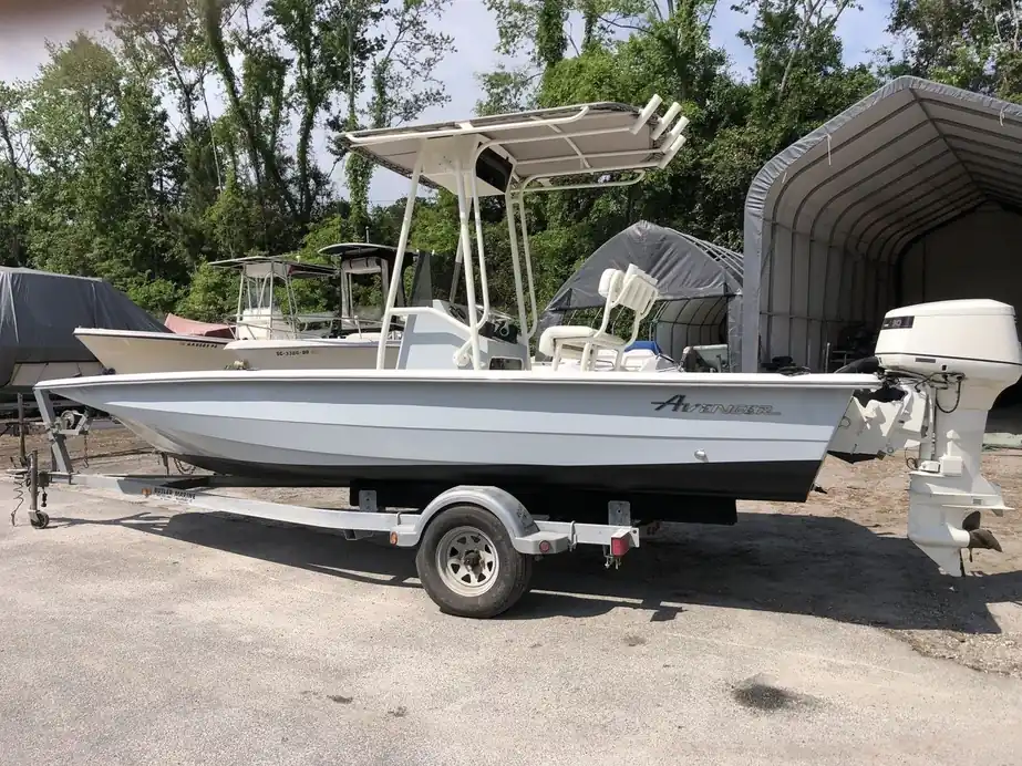 White flats boat with a black boot band and T-top on a trailer