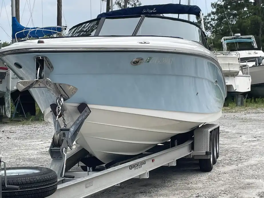 Close-up of a pale-blue and white hull on a trailer with an anchor aboard